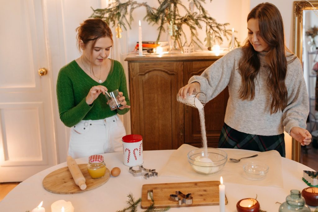 a couple are decorating christmas cookies